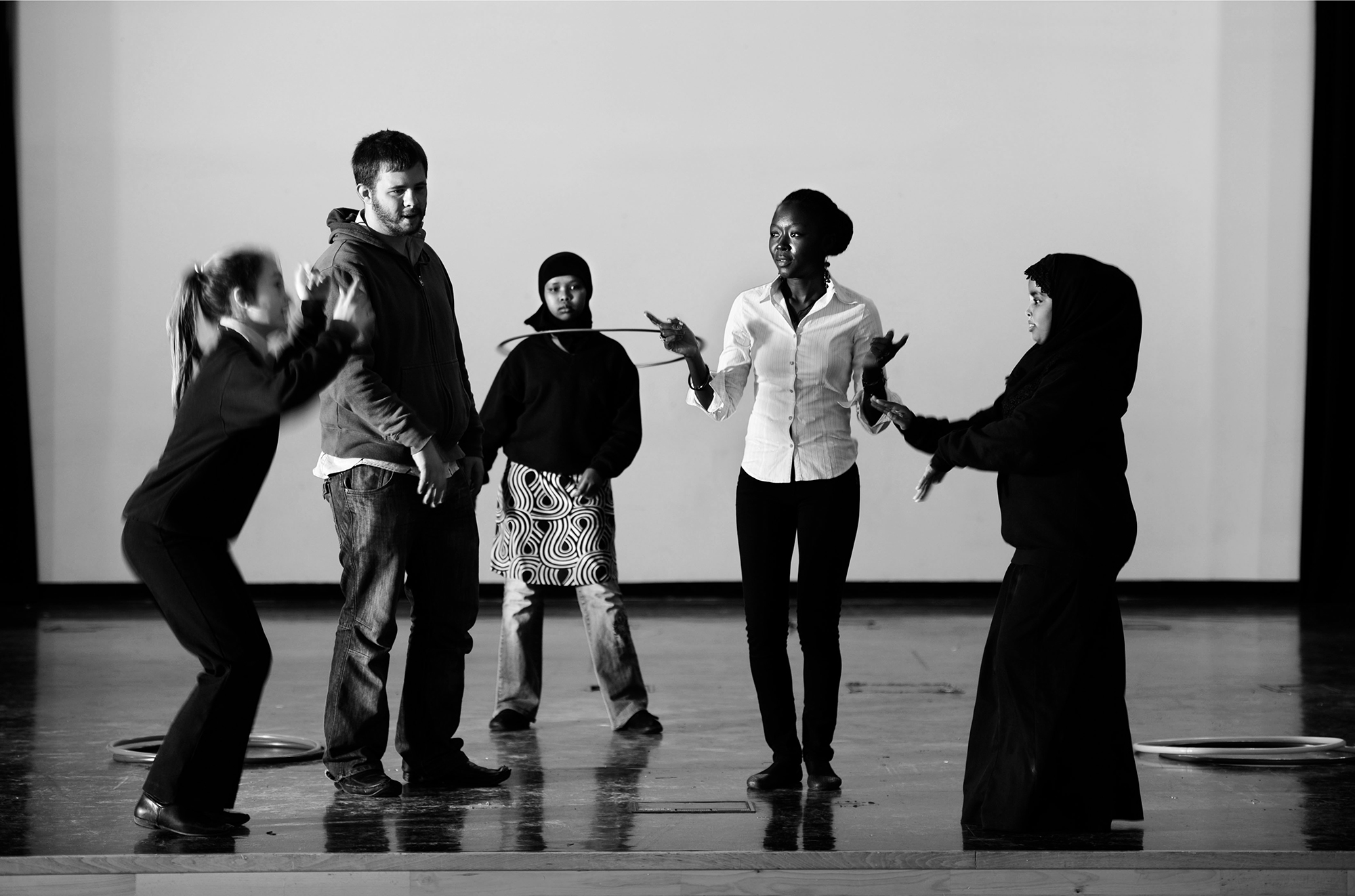 Kenyan youngsters in Bristol as part of a cultural exchange in which youths from developing countries do voluntary work in UK. They are all standing on a stage, one student is using a hula hoop