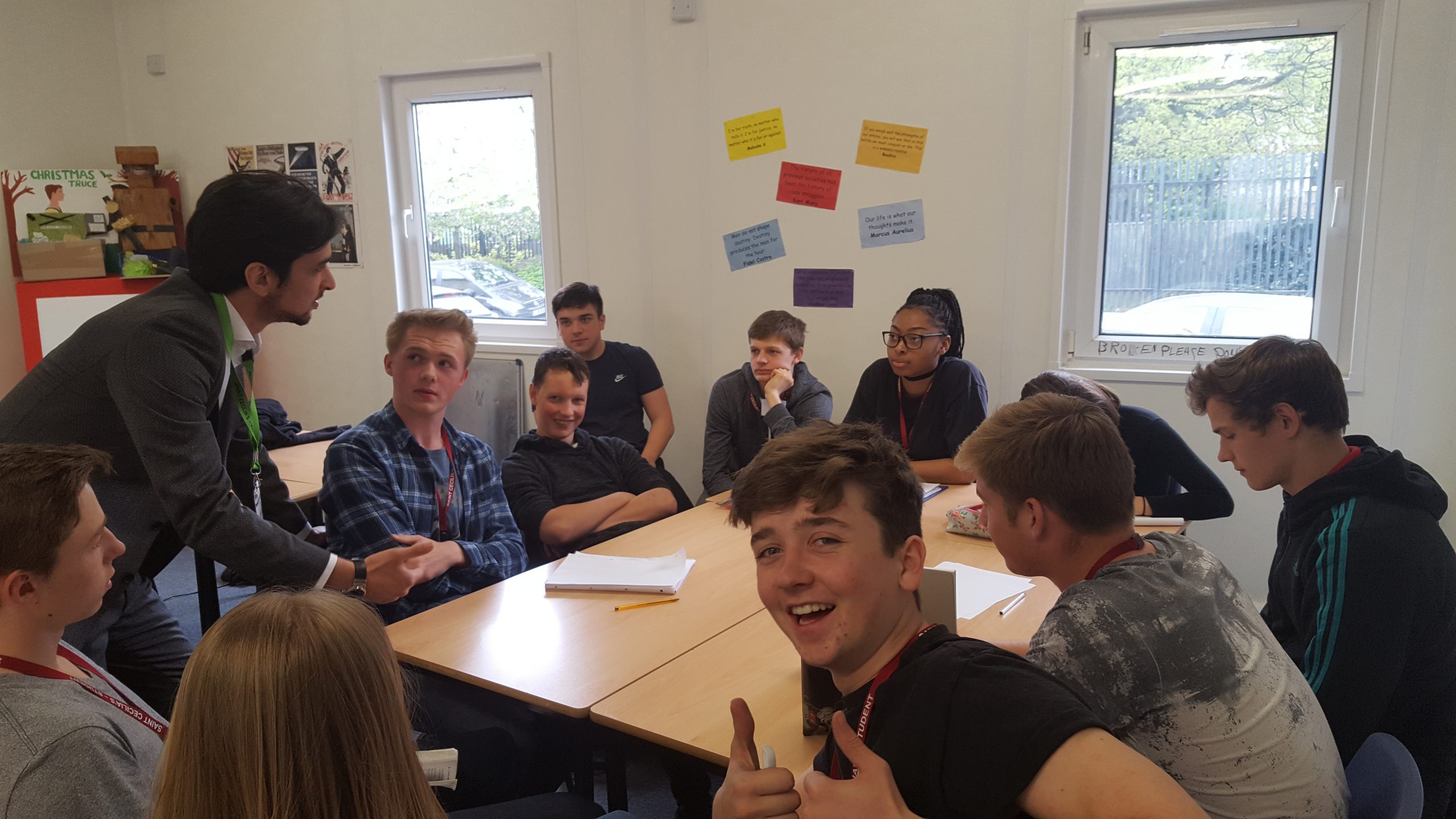 Image of young people sat around a table.