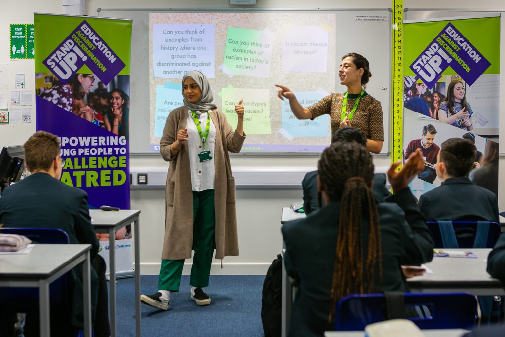 Image of Stand Up! delivering a workshop to a classroom of young people.