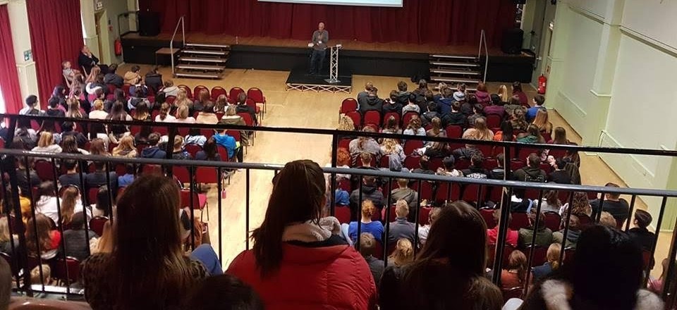 Image of a school assembly with pupils